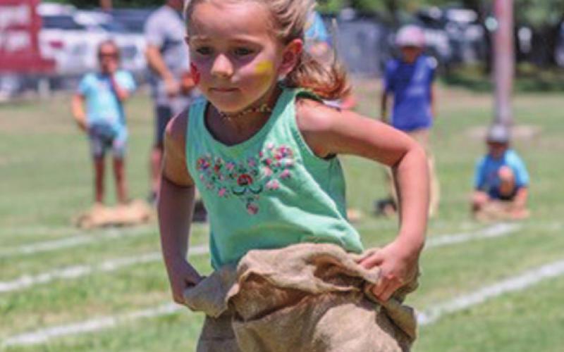 Mili Argo participates in the sack race competition at Kids’ Day. CHRIS MILES | DISPATCH RECORD