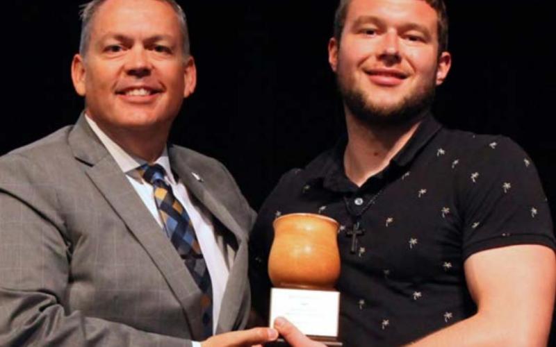 Howard Payne University President Dr. Cory Hines presents the Dr. Nat Tracy Servant Leader Award to Matthew Martin. COURTESY PHOTO
