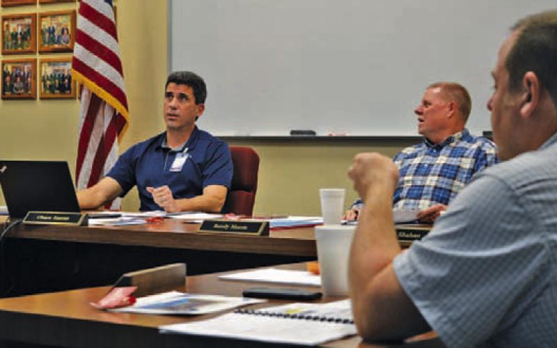 Lampasas Independent School District Superintendent Chane Rascoe, left, and Board of Trustees President Randy Morris discuss LISD state assessment scores during Monday’s meeting. At right is trustee Sam Walker. ERICK MITCHELL | DISPATCH RECORD