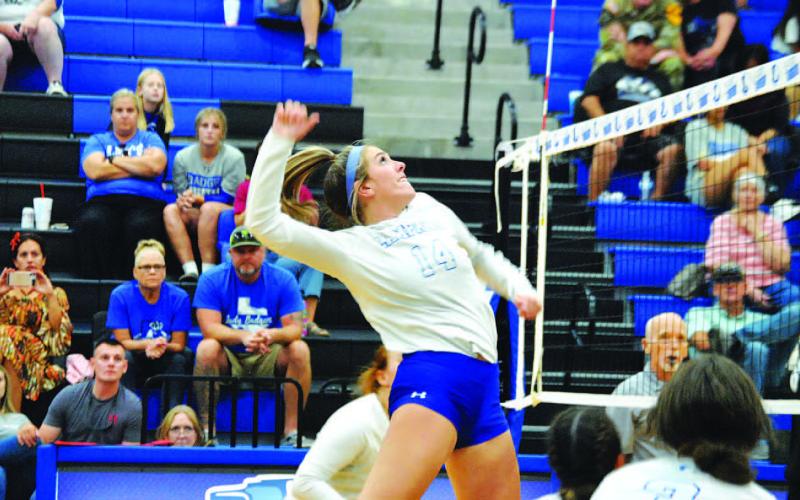 Avery Bolm jumps for a spike in a game at home earlier this season. HUNTER KING | DISPATCH RECORD
