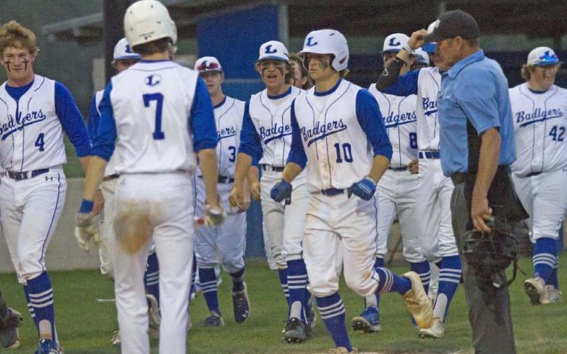 Ace Whitehead (10) crosses the plate on his two-run home run. Teammates celebrating the play include Gauge Gholson (4), Nate Borchardt (7), Carson Bekker (3), Elijah Stanley (next to Whitehead), Tak Stinnett (8) and Hayden Waldrip (42). JEFF LOWE | DISPATCH RECORD