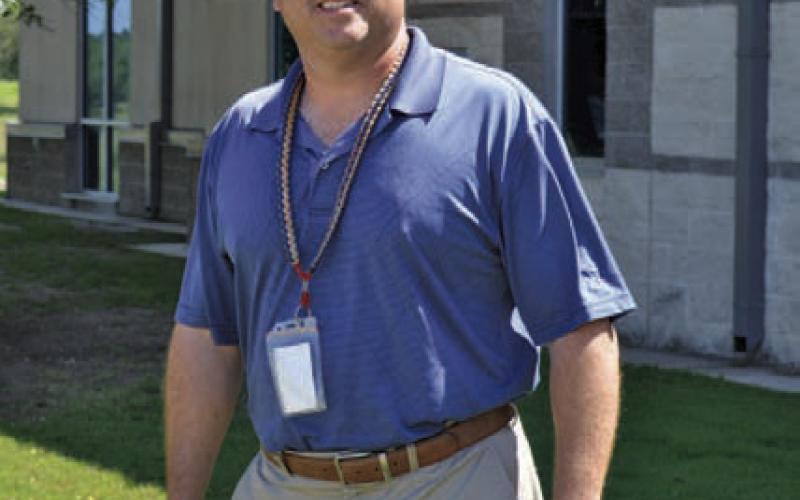 Paul Weinheimer stands outside Lampasas High School, where he has gone from teacher and football coach to assistant principal to now principal at the campus. ERICK MITCHELL | DISPATCH RECORD