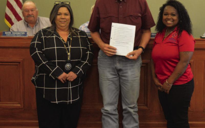 County Judge Randy Hoyer holds a proclamation naming June as Elder Abuse Awareness Month. He is joined by Isabel Jones, left, and Mariah Douglas from the Texas Adult Protective Services agency after the Lampasas County Commissioners Court ratified the proclamation last week. ERICK MITCHELL | DISPATCH DISPATCH