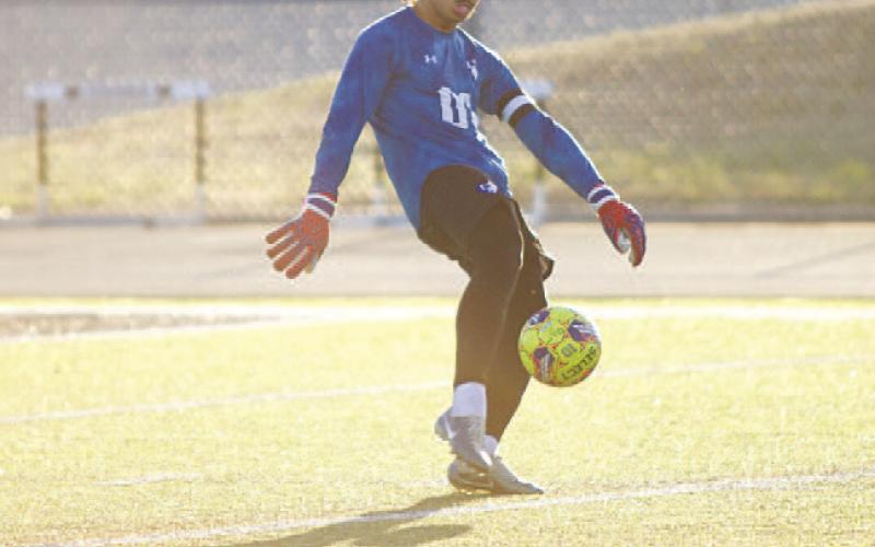 Michael Clayton kicks the ball down the field during last Friday’s match. HUNTER KING | DISPATCH RECORD