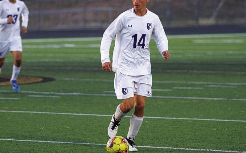 HUNTER KING | DISPATCH RECORD Tyler Ecker dribbles and look to pass to a teammate in the final road district game of the season.