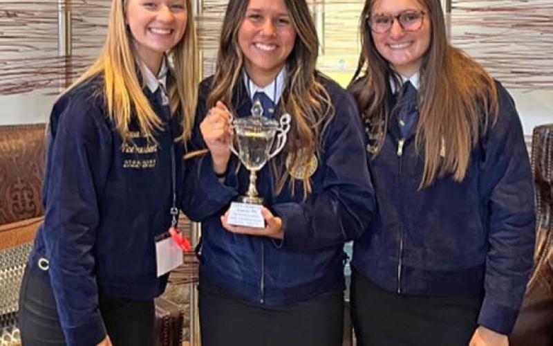 Lampasas FFA members walked the stage of champions last week at the Texas FFA Convention. The Ag Communications team of, from left, manager Daecee Ellis, Paige Rutland, Jacie Resa, and members not pictured Morgan Bobo and Avery Hopson received their state champion trophy. They will compete for the national title in November in Indianapolis. COURTESY PHOTO | JUDY HAIL