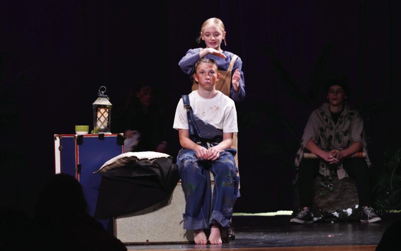 Lampasas Middle School theatre students had a public performance of their One-Act Play “Wiley and the Hairy Man” on Friday at Lampasas High School. Wiley, portrayed by Holley Wakeman, receives some assistance from Mammy, played by Adalya White, who stands behind Wakeman. ERICK MITCHELL | DISPATCH RECORD