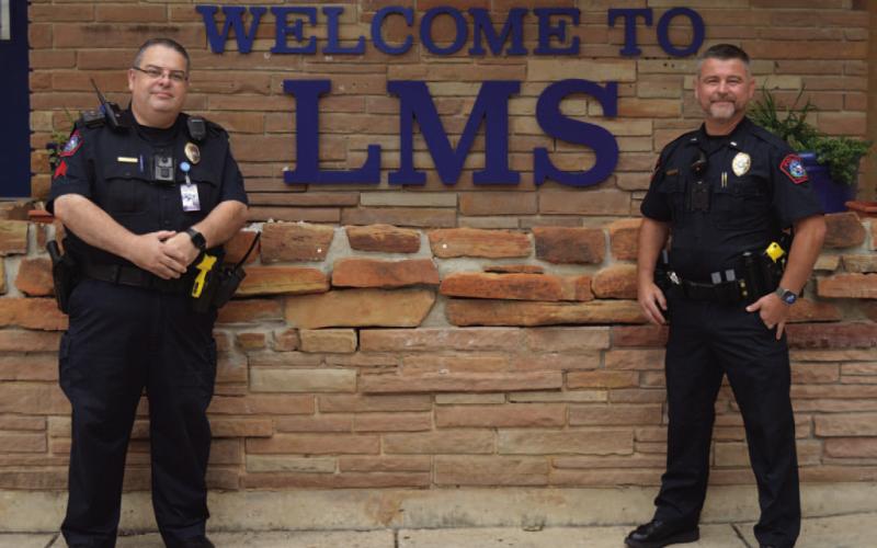 Sgt. Steve Sheldon, at left, and Patrol Lt. Chuck Montgomery of the Lampasas Police Department stand outside Lampasas Middle School. Sheldon is a school resource officer at the campus and supervises the other SROs in the school district, while Montgomery oversees the program. Lampasas ISD and the city of Lampasas have an agreement to provide at least one police officer per campus to enhance safety measures in place. ERICK MITCHELL | DISPATCH RECORD