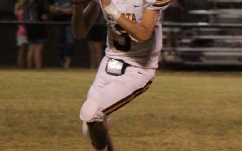 Alonso Caso looks downfield for a receiver during the Hornets’ win on Friday. JESSICA MALDONADO | DISPATCH RECORD