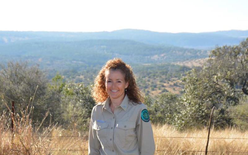 COURTESY PHOTO | JEFF LOWE Post Oak Ridge State Park Superintendent Kacey Sloan is entering her fifth year as a Texas Parks and Wildlife employee. She is shown along the southern boundary of the new state park, with rolling hills in Burnet County in the background.