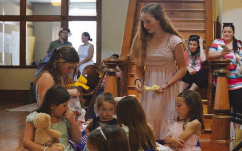 Jordyn McKittrick, center, helps serve Teddy Tea Party ttendees their refreshments during Saturday’s event at the M.D. Abel Building. ERICK MITCHELL | DISPATCH RECORD