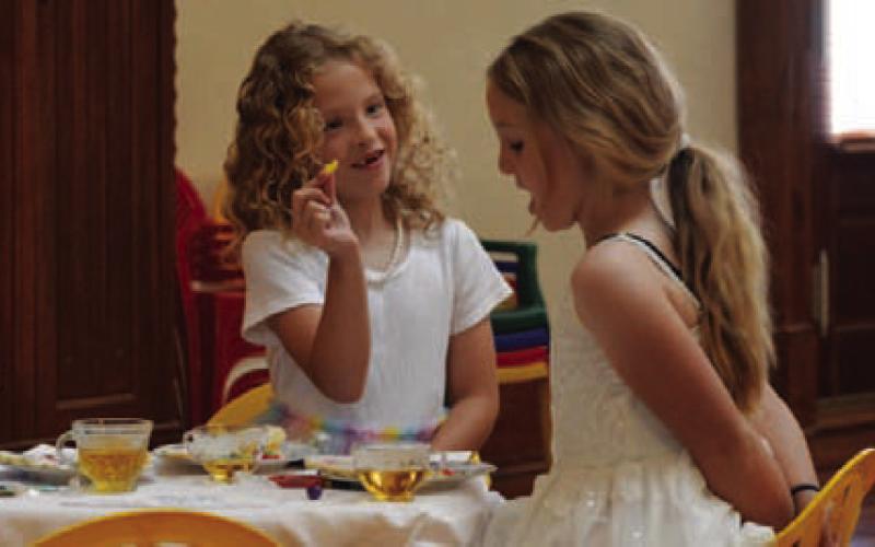 At left, Rose Baltrun offers up a snack to a friend. ERICK MITCHELL | DISPATCH RECORD