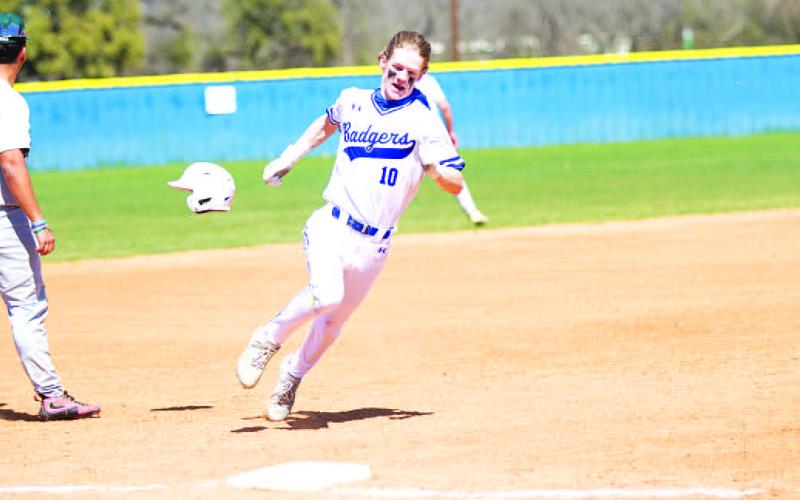 Peyton Sisson’s helmet flies off as he rounds third base and heads toward home plate. HUNTER KING | DISPATCH RECORD