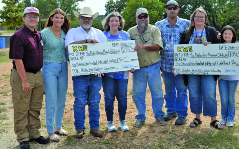 Kline Whitis Elementary School students raised more than $3,900 for the Peyton Jones Memorial Scholarship and the Michael January Memorial Scholarship. Pictured at left are second-grade teacher Amy Brown and her family, representing the January scholarship, and Shante Seward, second from right, with her family, representing the Jones scholarship. ERICK MITCHELL | DISPATCH RECORD