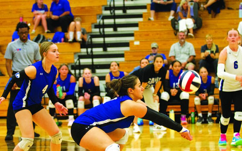HUNTER KING | DISPATCH RECORD Jacie Resa makes a pass off a serve to set up the Lady Badgers’ offense.