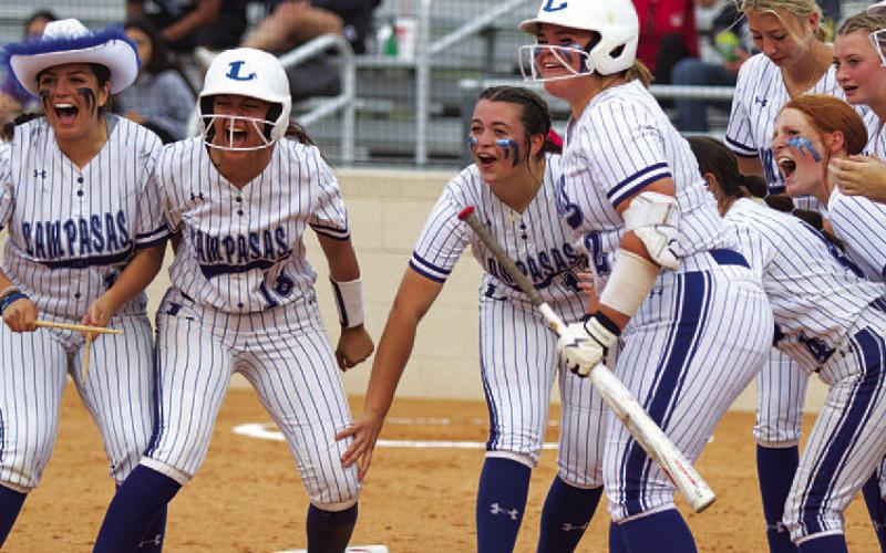HUNTER KING | DISPATCH RECORD From left, Julia Ybarra, Madison Magilke, Brooklyn Farmer and Amari Munoz along with the rest of the Lady Badgers await Wheeler at home plate.
