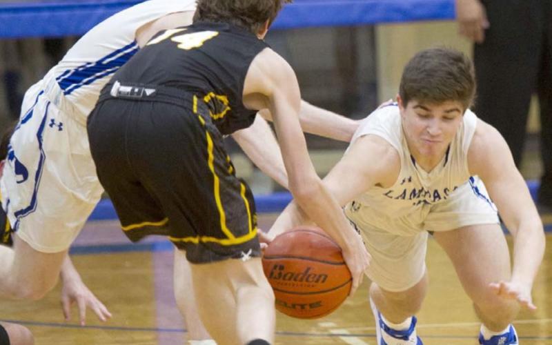 Dax Brookreson (right) dives for a steal. He had seven steals as Lampasas beat Gatesville 89-42 at home on Friday. JEFF LOWE | DISPATCH RECORD