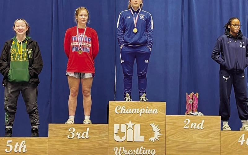 Taylor Martell stands atop the podium after winning the regional meet last week. HUNTER KING | DISPATCH RECORD