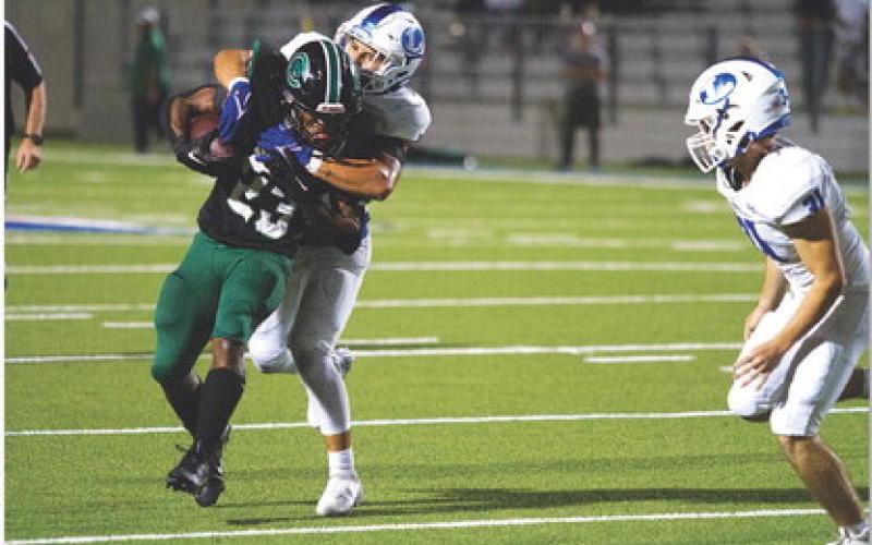 HUNTER KING | DISPATCH RECORD Elijah Calderon wrangles the Pflugerville Connally ball carrier.