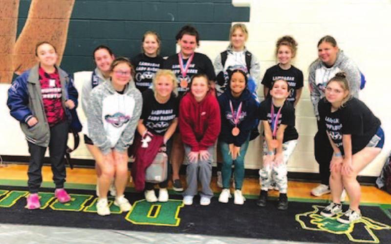 The Lady Badger powerlifting team poses with its medals after finishing in the top half of teams in the region. COURTESY PHOTO