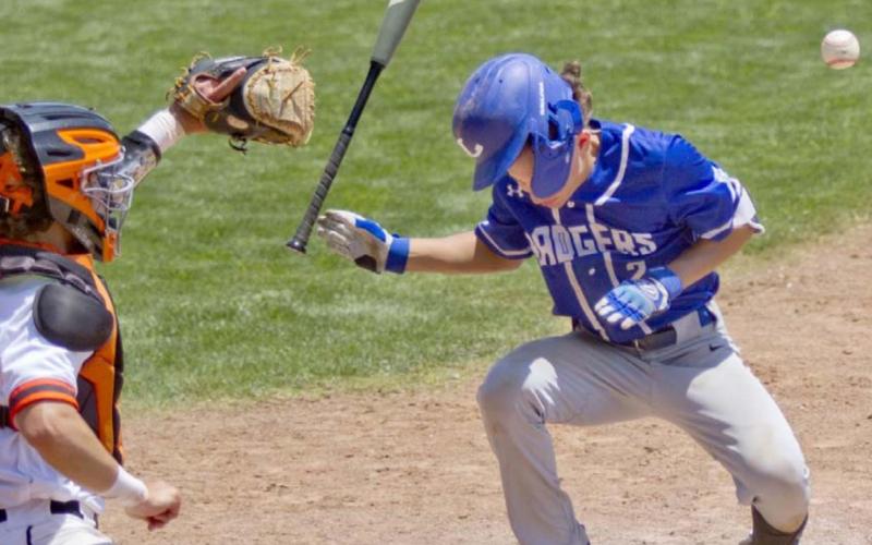Elijah Stanley takes one for the team with a hit-by-pitch off the helmet that drove in a run in his last Badger baseball game. JEFF LOWE | DISPATCH RECORD