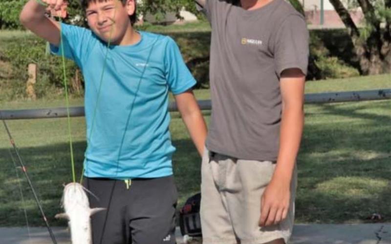 From the left, Mason Miller and Alex Miller hold one of the more than 20 catfish they caught. CHRIS MILES | DISPATCH RECORD Miller hold one of