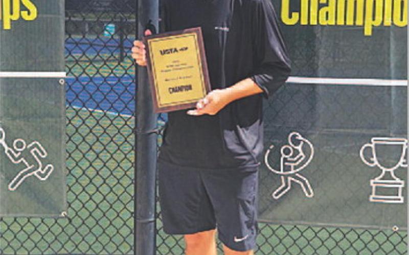 Eric White poses with his plaque from winning the national tennis tournament in Orlando. COURTESY PHOTO