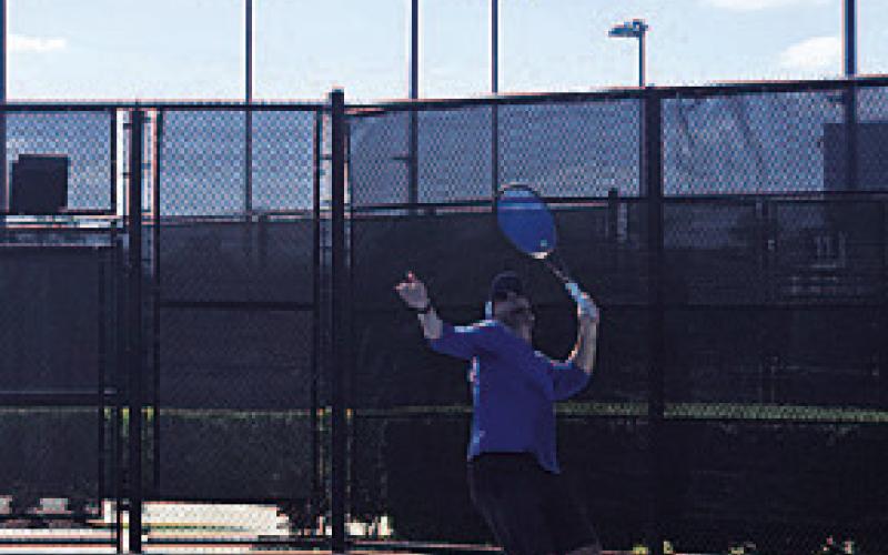 White prepares to swing through a serve. COURTESY PHOTO