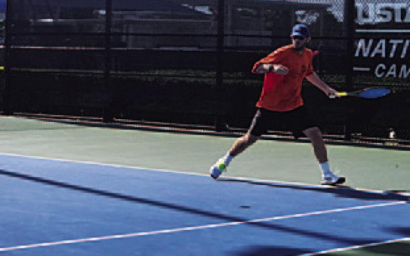 COURTESY PHOTO The tennis coach keeps his eyes on the ball during the tournament.
