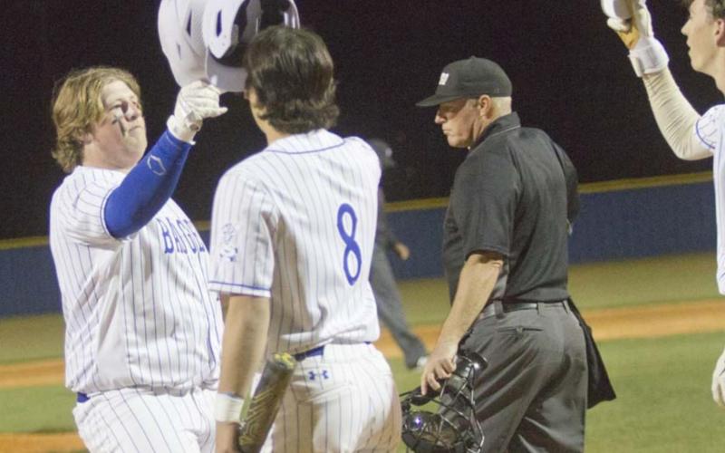 First baseman Hayden Waldrip, left, Tak Stinnett and other teammates celebrate Waldrip’s three-run homer in the seventh inning. That shot cut the Hornets’ lead down to one run, but Gatesville still defeated Lampasas. JEFF LOWE | DISPATCH RECORD