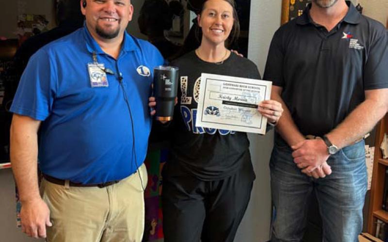 COURTESY PHOTO Kristy Morua was named the Support Staff of the Month at Lampasas High School. Assistant Principal Ryan Race, at left, said Morua is willing to step in and always has a smile on her face. “She is the ultimate team player,” he said. Also pictured is Clay Phillips of Texas Farm Bureau Insurance, who helped recognized Morua. Not pictured: Substitute of the Month Ann Bechtel.
