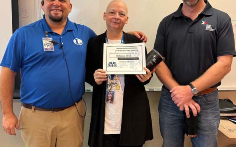 Patricia Bird was chosen as a Teacher of the Month for October. Assistant Principal Ryan Race said Bird is an excellent math teacher. “She comes in with a positive attitude and spreads love to all her students,” he added. Clay Phillips, at right, also was on hand to congratulate Bird. COURTESY PHOTO