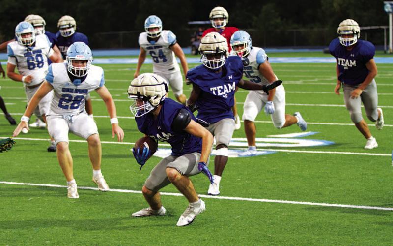 Shawn Roberts makes a move to evade a China Spring defender during the second scrimmage. HUNTER KING | DISPATCH RECORD