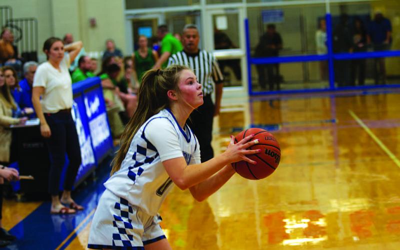 Addison Borchardt lines up a three-point shot. HUNTER KING | DISPATCH RECORD