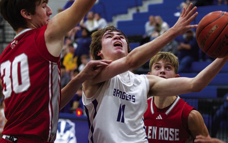 Jax Pratus fights through contact to finish at the rim against Glen Rose during the Badgers’ game. HUNTER KING | DISPATCH RECORD