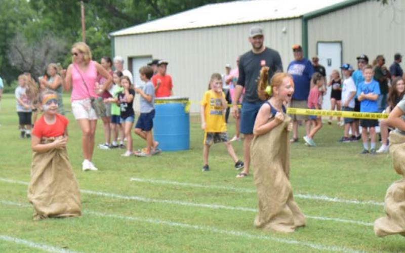 Kids hopped their way to the finish line in this year’s sack race during Kids’ Day last Friday. The event was part of the town’s Spring Ho festival. MONIQUE BRAND | DISPATCH RECORD