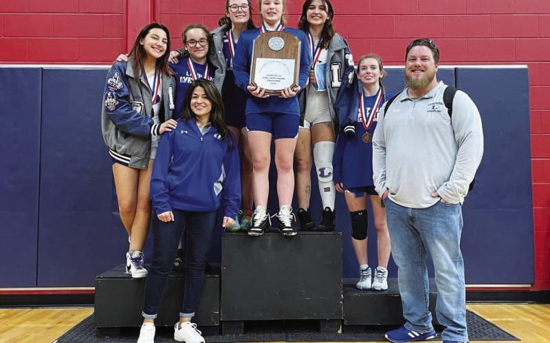 The girls’ wrestling team poses with their district championship plaque after winning in Georgetown on Wednesday. COURTESY PHOTO | LISD ATHLETICS FACEBOOK
