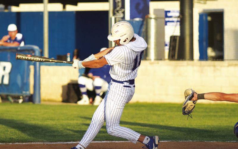 Tripp Stinnett continued swinging a hot bat as he drove this ball into the gap. HUNTER KING | DISPATCH RECORD