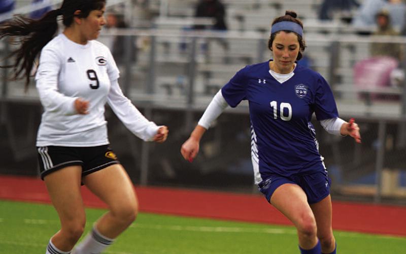 Liliana Fryer dribbles past a defender. As a freshman, she has been an important player this season. FILE PHOTO