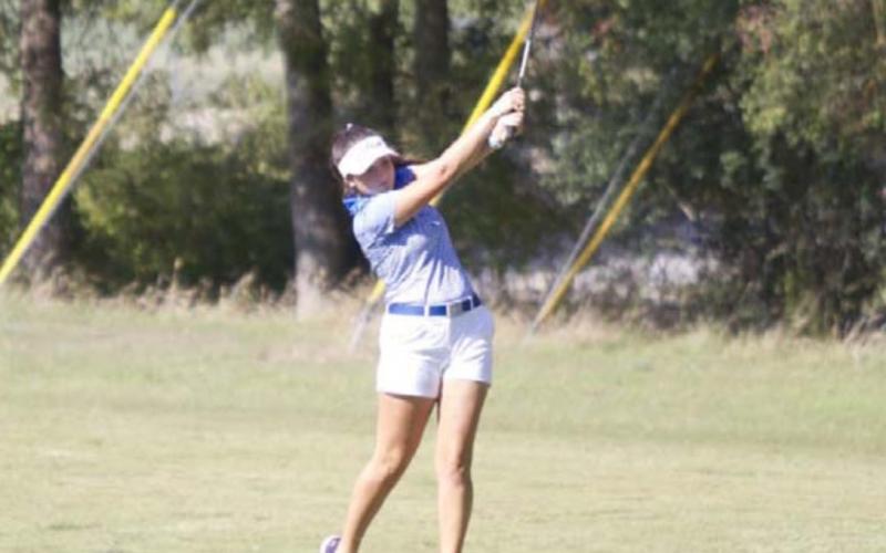 Paige Rutland finishes on a shot from the fairway on hole 5 at Hancock Park Golf Course. HUNTER KING | DISPATCH RECORD