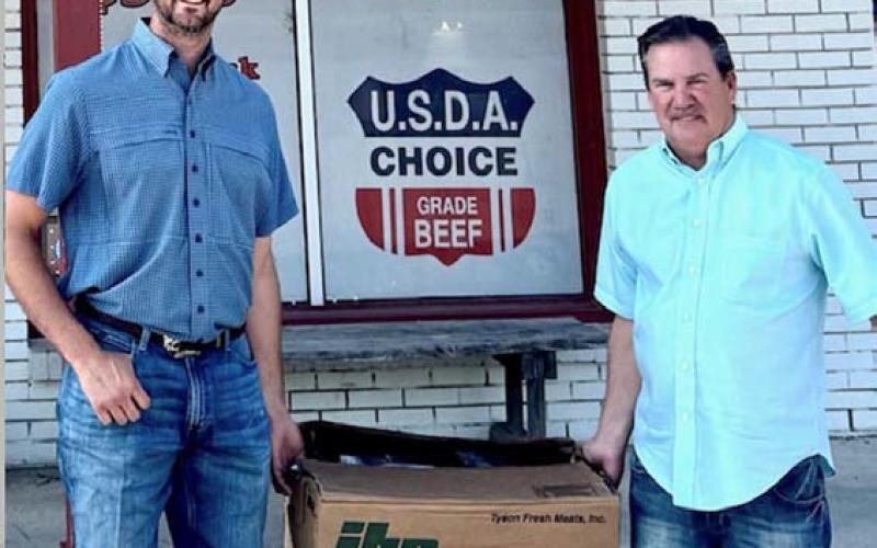 Courtesy photo Lampasas County Farm Bureau President Heston McBride, left, visits with new Farm Bureau member Daryl Raub, who picked up his Family Meat Pack, valued at $250, from M&amp;amp;M Butcher Block.