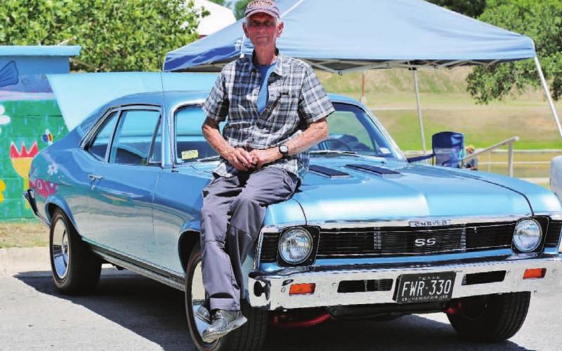 Jones sits on the hood of the same vehicle at Saturday’s car cruise in Lampasas. CHRIS MILES | DISPATCH RECORD