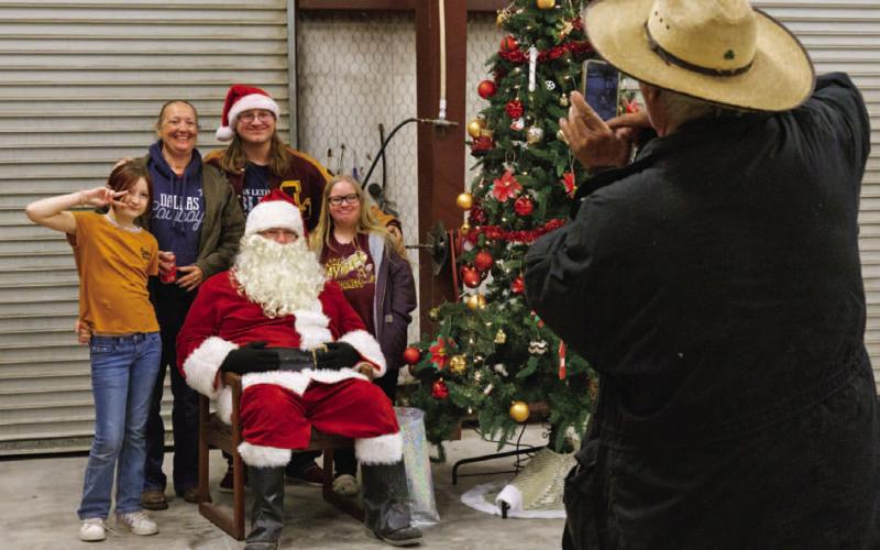 Lometa families had the opportunity to pose with Santa Claus for a photo at the annual Lometa Hometown Christmas Celebration on Saturday evening. ADAM BARRIOS | DISPATCH RECORD