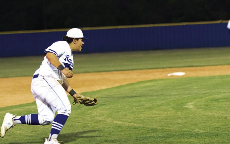 HUNTER KING | DISPATCH RECORD Benny Rodriguez fields a slowly hit ground ball and prepares to throw across the diamond.