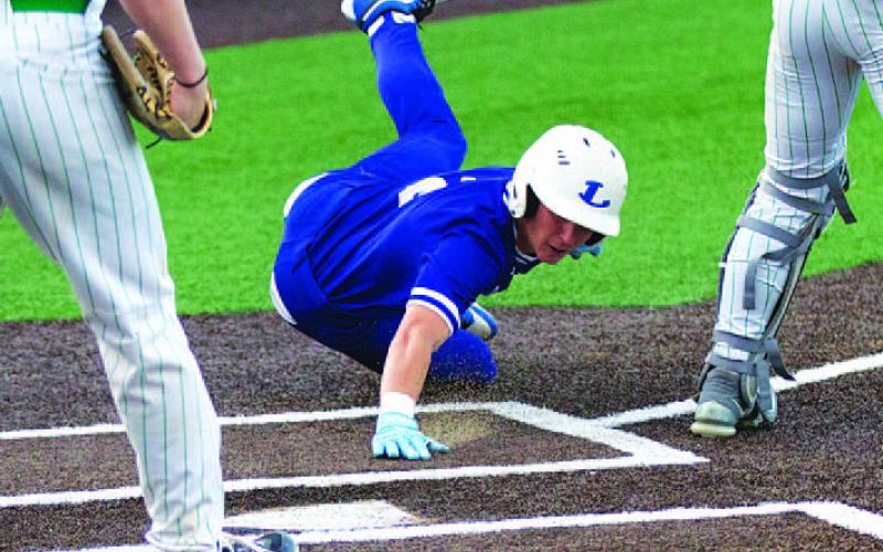 HUNTER KING | DISPATCH RECORD JT Posten slides into home plate to score the Badgers’ second run of the first inning against Burnet on Tuesday.