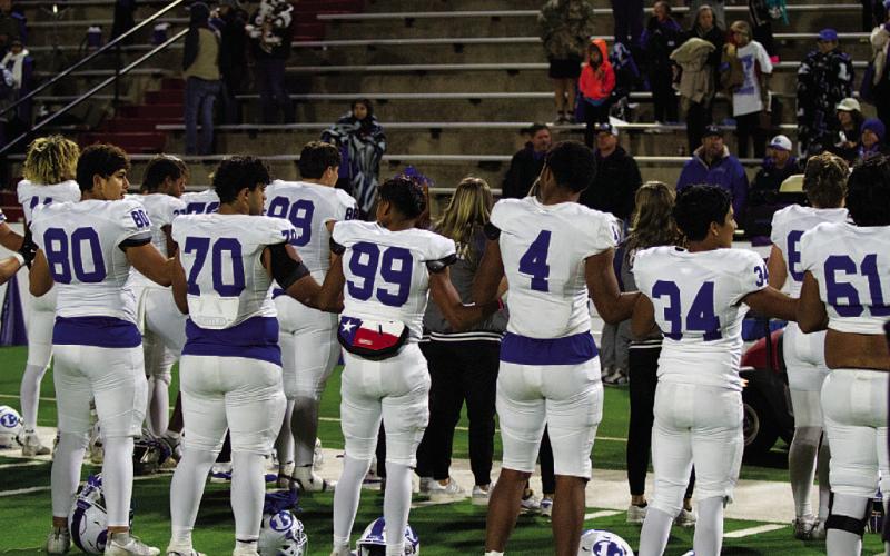 Members of the Badger football team take in the alma mater played by the Lampasas band. HUNTER KING | DISPATCH RECORD