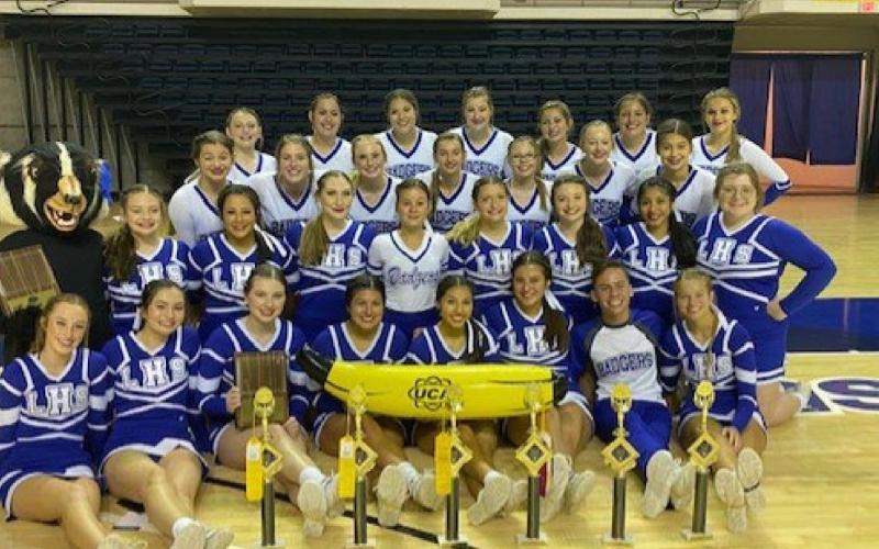 The Lampasas High School varsity and junior varsity cheer teams pose with their trophies at the Universal Cheerleaders Association camp at San Angelo State last month. COURTESY PHOTO