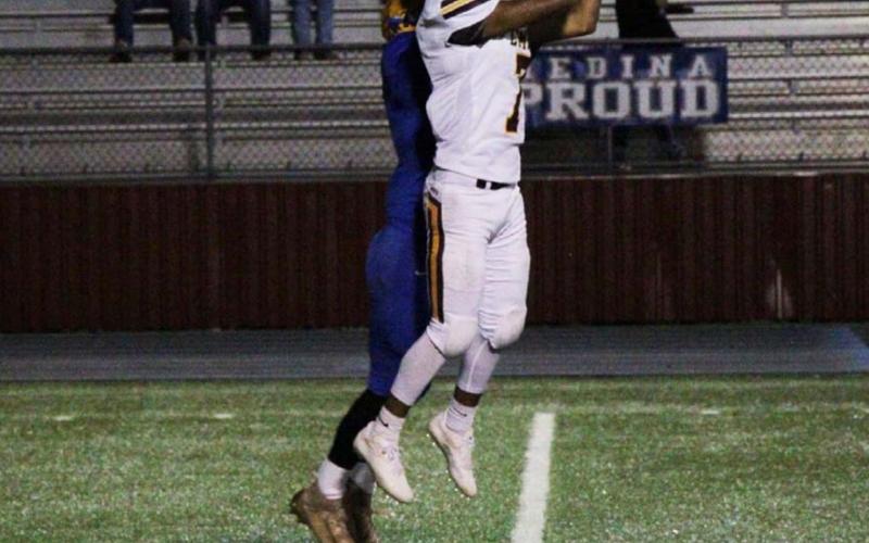 Leonel Caso goes up to catch a pass against a Medina defender. JESSICA MALDONADO | DISPATCH RECORD