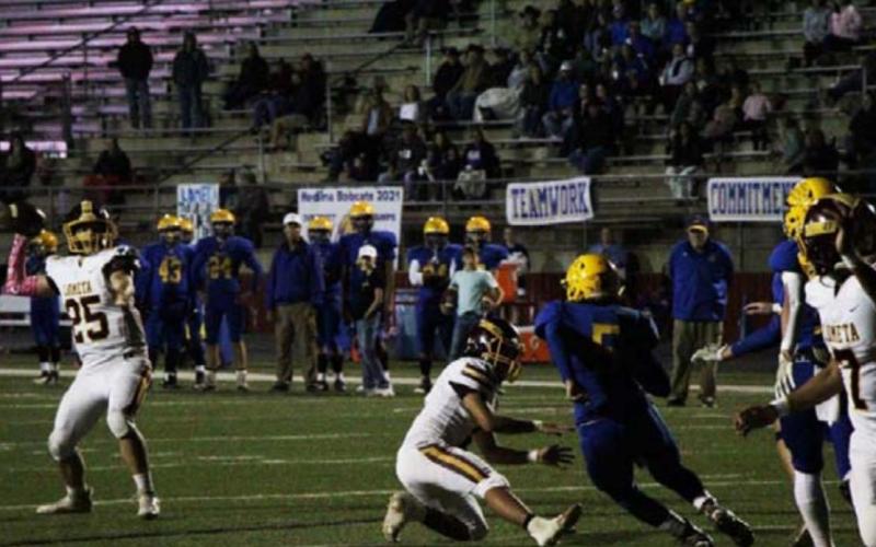 Donnie Smart (25) looks to pass to Leonel Caso during the Medina game. JESSICA MALDONADO | DISPATCH RECORD