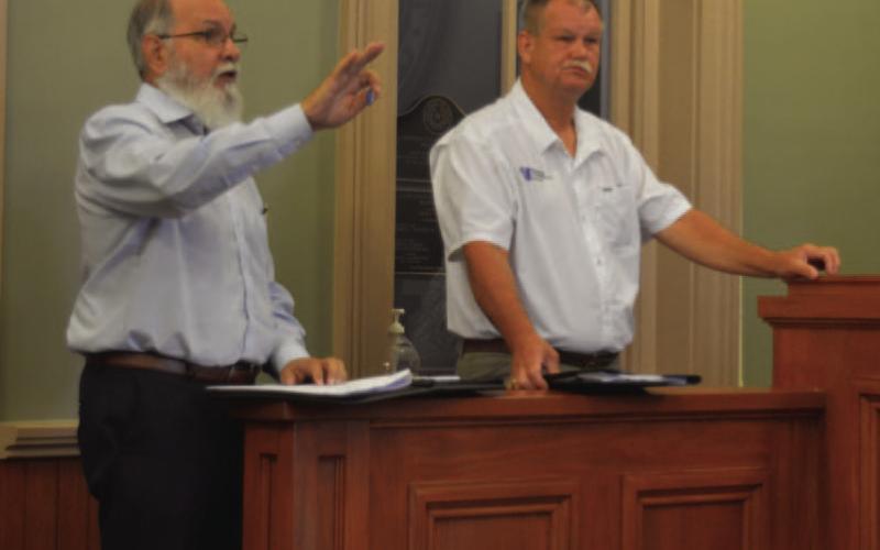 At left, Komatsu Architecture Design Coordinator Rick Stacy and Premier Construction’s Lee Evans discuss potential renovations to the county courthouse. Their comments came during Monday’s Lampasas County Commissioners Court meeting. ERICK MITCHELL | DISPATCH RECORD